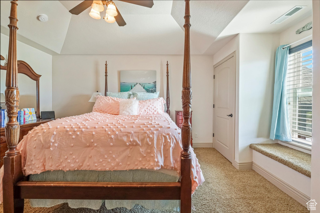 Carpeted bedroom featuring baseboards and a ceiling fan