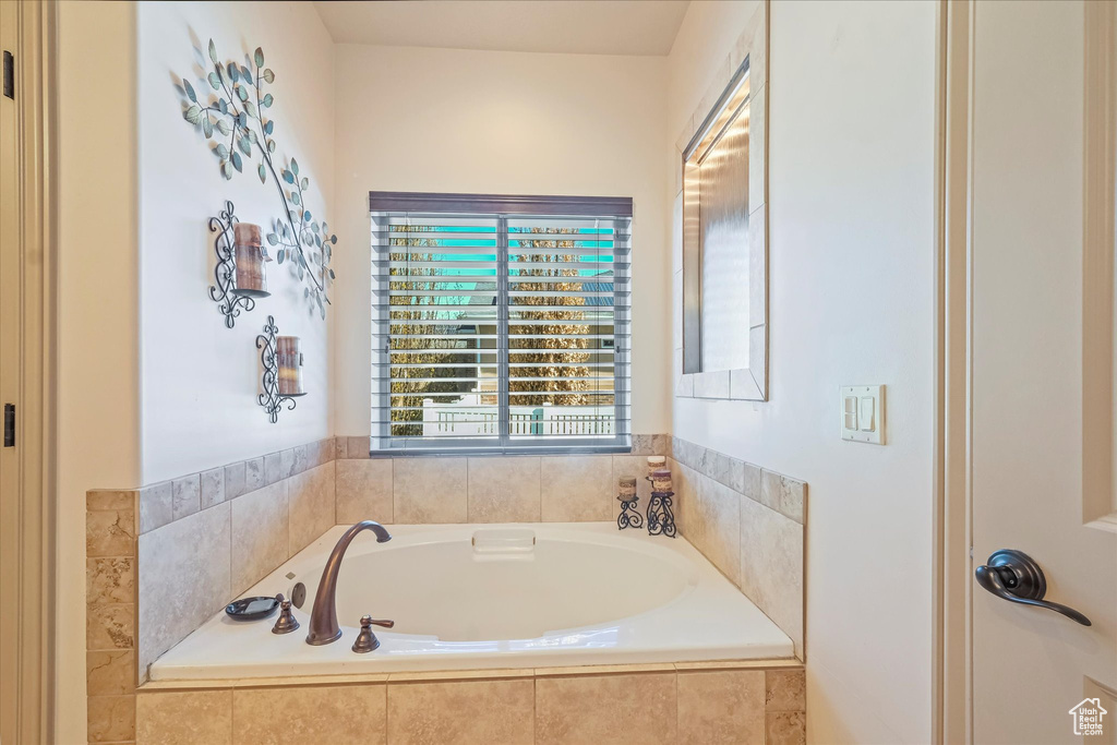 Full bathroom featuring a bath