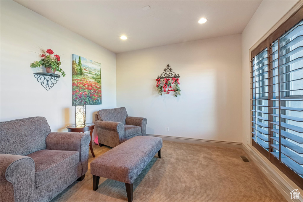 Living area with carpet flooring, recessed lighting, and baseboards