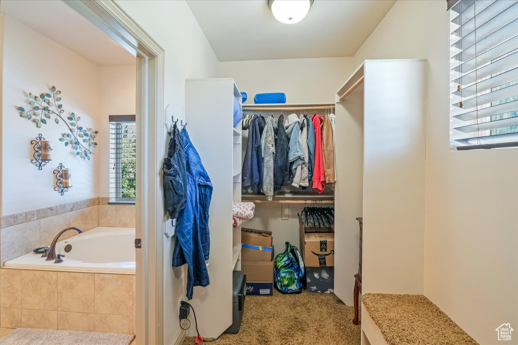 Bathroom featuring a garden tub and a spacious closet