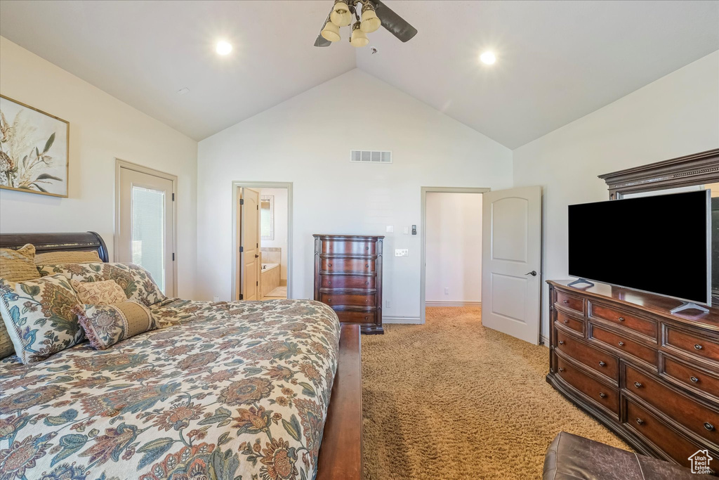 Bedroom featuring light carpet, high vaulted ceiling, connected bathroom, a ceiling fan, and baseboards