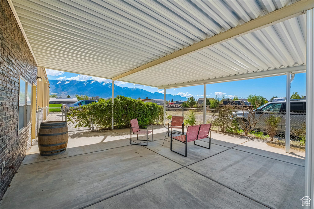 View of patio / terrace with a mountain view and fence