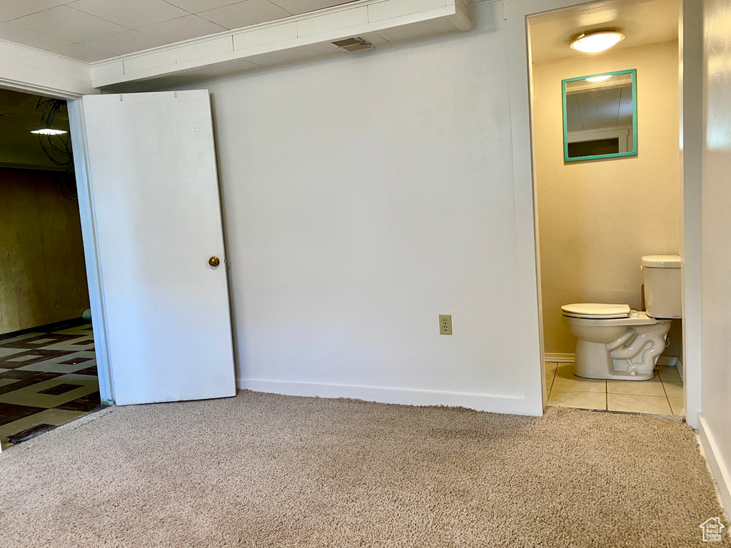 Unfurnished bedroom with light carpet and ensuite bath