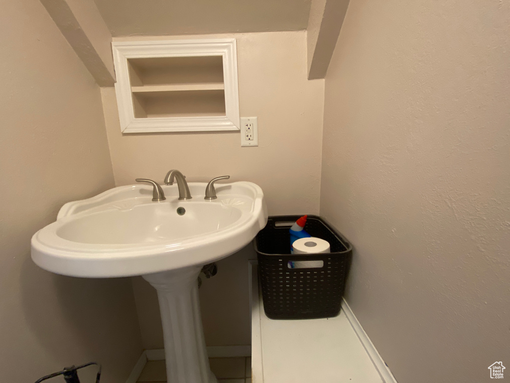 Bathroom featuring a sink and tile patterned flooring