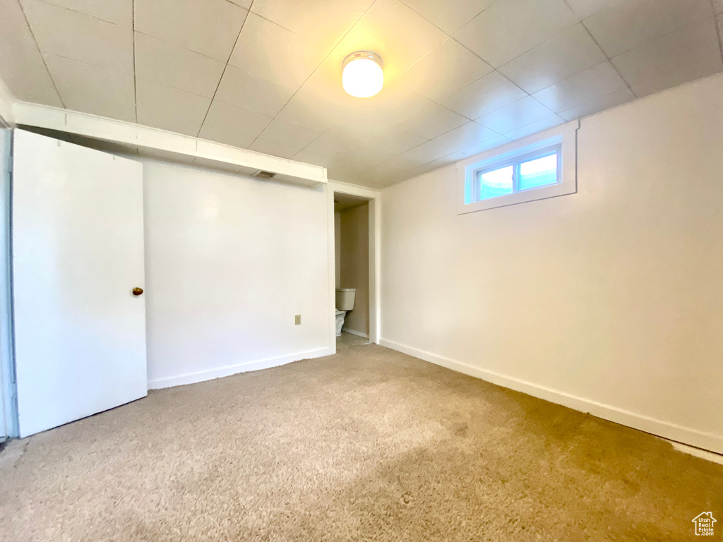 Below grade area featuring carpet and baseboards