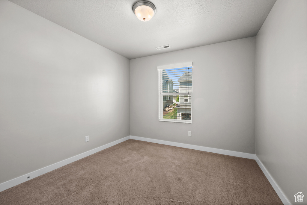 Unfurnished room with carpet floors and baseboards