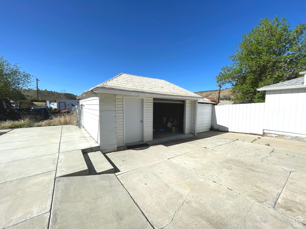 Detached garage featuring fence