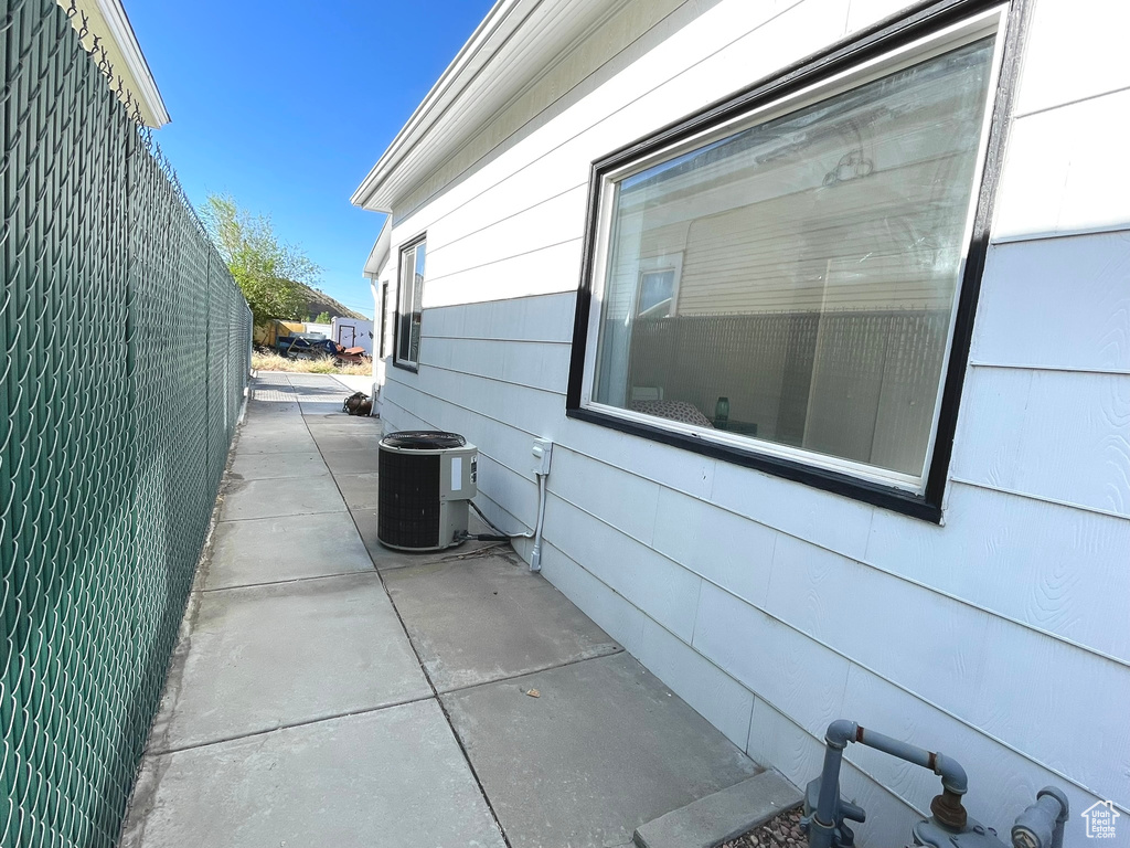 View of home\\\\\\\'s exterior with cooling unit and a patio