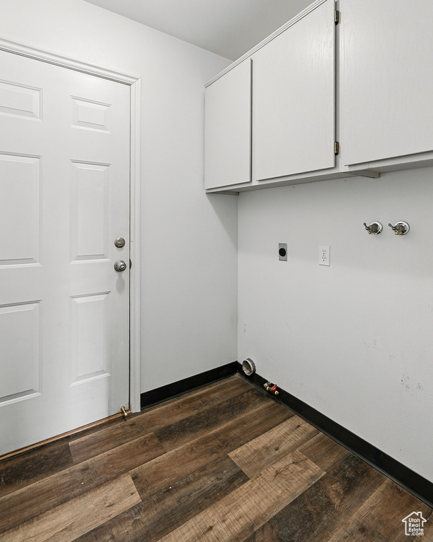 Laundry room with gas dryer hookup, cabinet space, dark wood-style flooring, hookup for an electric dryer, and hookup for a washing machine
