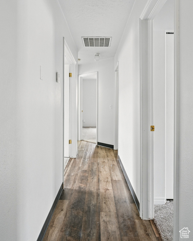 Corridor featuring hardwood / wood-style flooring and baseboards