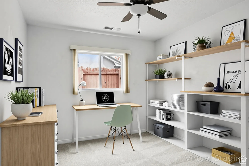 Carpeted office with ceiling fan and baseboards