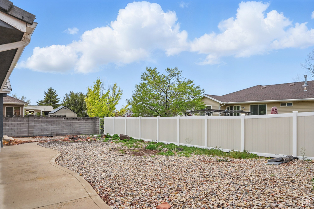 Fenced backyard with a patio