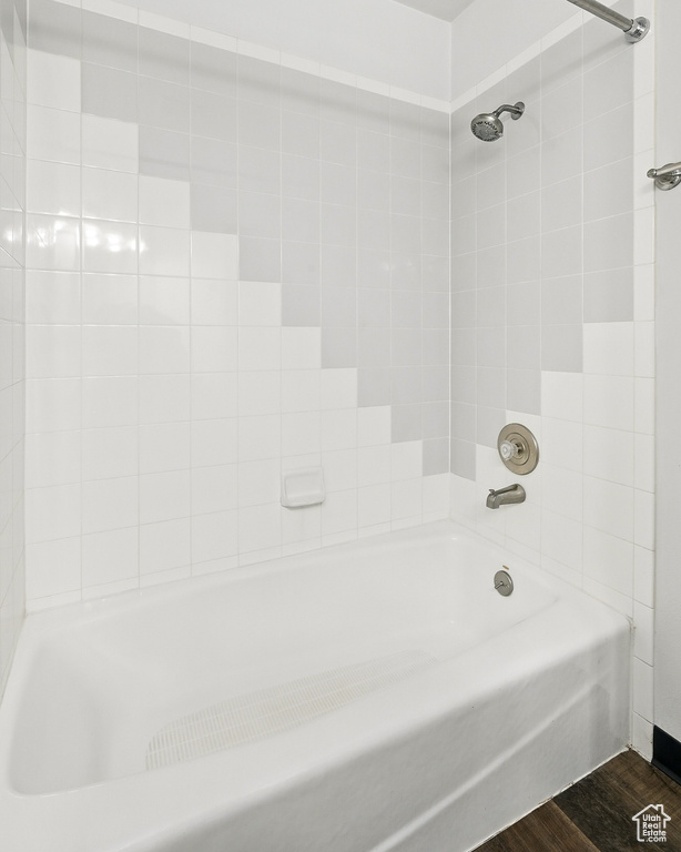 Bathroom with wood finished floors and  shower combination