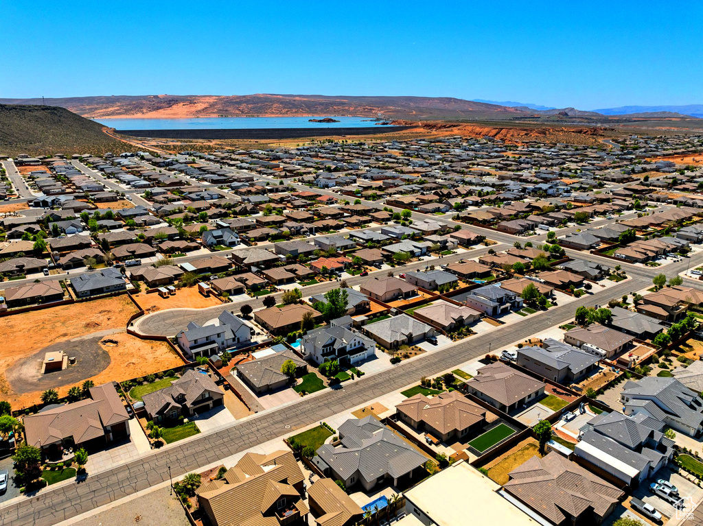 Drone / aerial view with a water and mountain view and a residential view