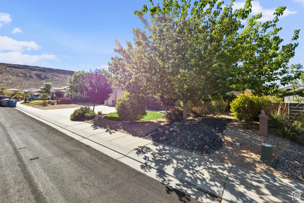 View of front of house featuring fence, driveway, and a mountain view