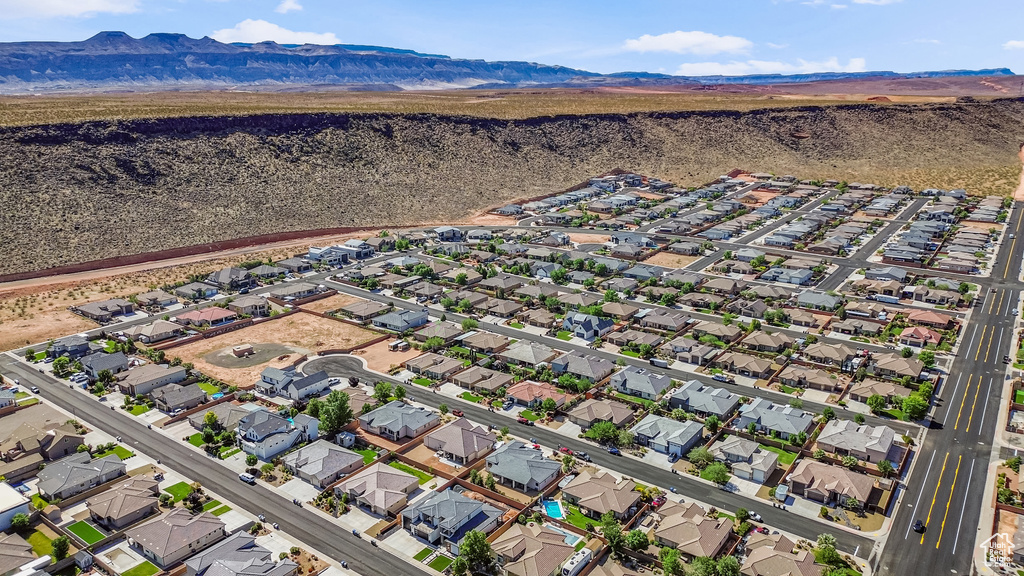 Aerial view of property\\\\\\\'s location featuring a mountainous background and nearby suburban area