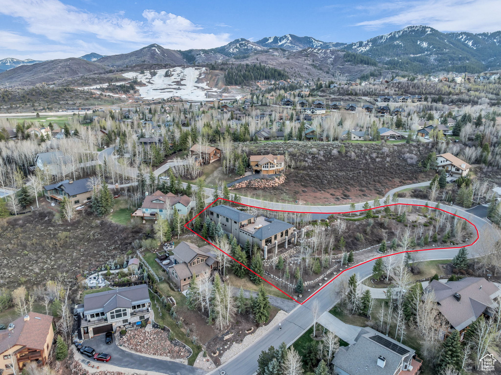 Aerial perspective of suburban area with a mountainous background and property parcel outlined