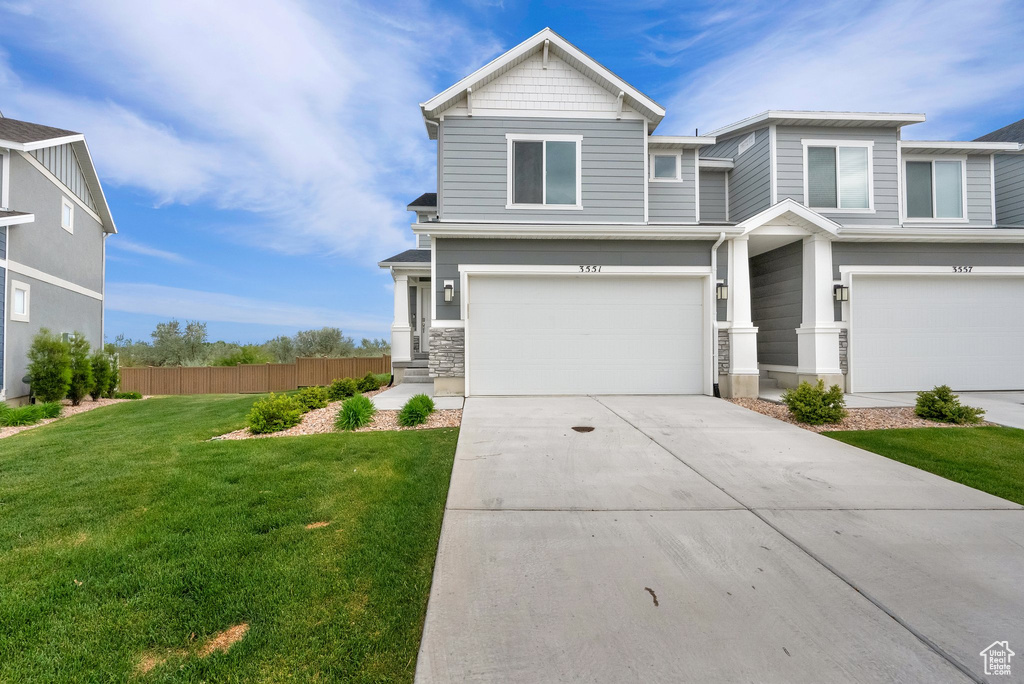 View of front of property featuring a garage and concrete driveway
