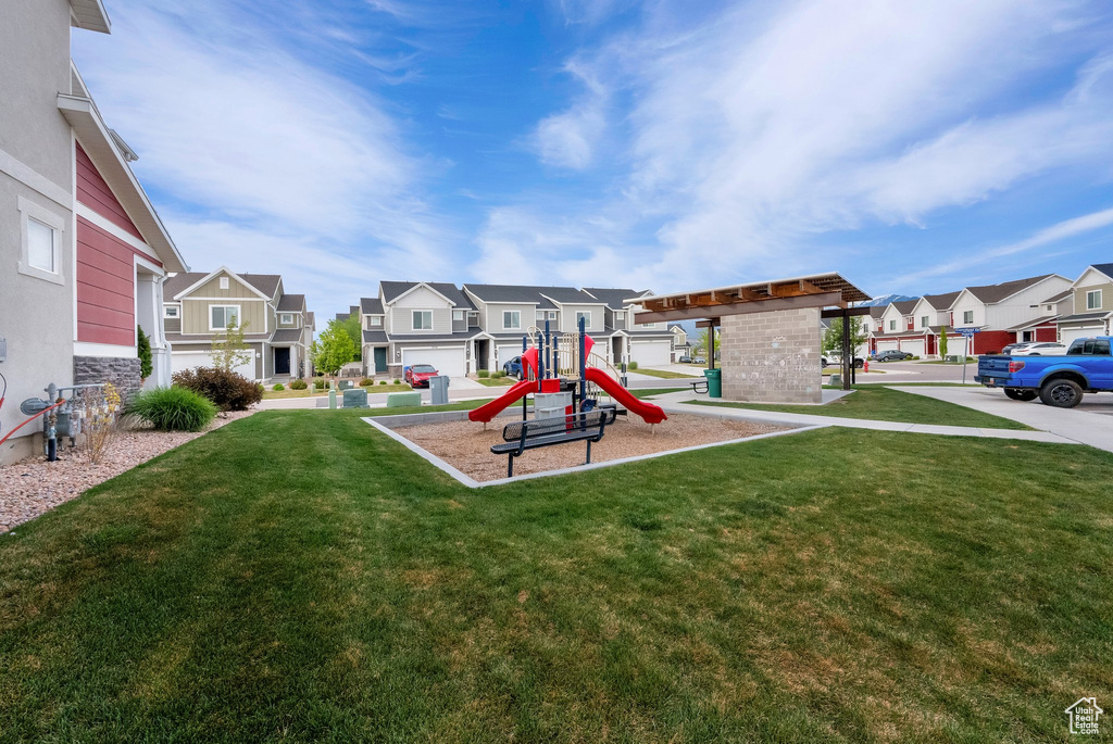 Community jungle gym featuring a residential view and a lawn