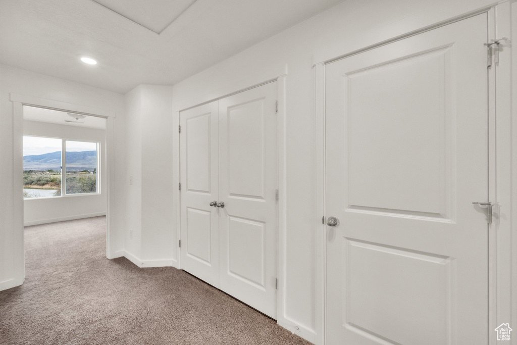 Hall featuring carpet, baseboards, recessed lighting, and a mountain view