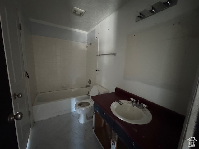 Bathroom featuring toilet, vanity, and  shower combination