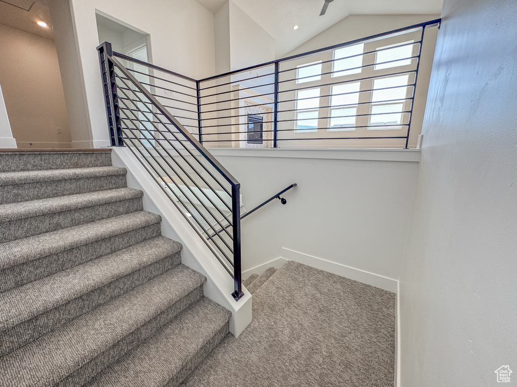 Stairs featuring carpet flooring, lofted ceiling, and recessed lighting