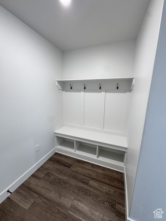 Mudroom with dark wood finished floors and baseboards