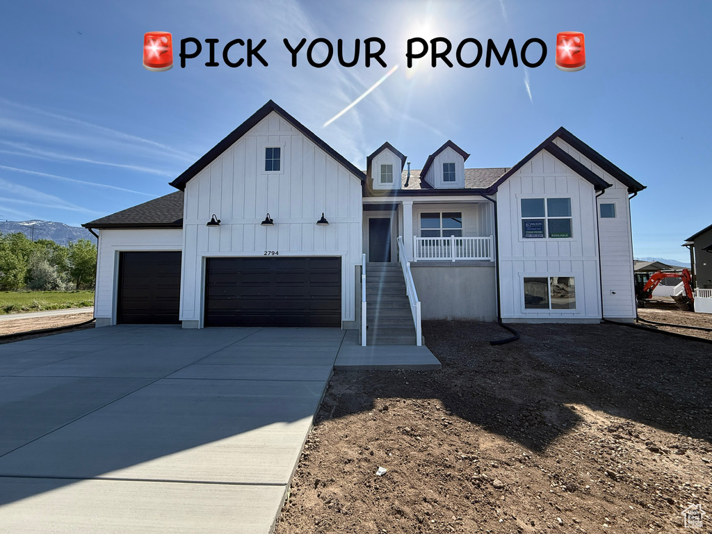 Modern inspired farmhouse featuring board and batten siding, stairs, an attached garage, a shingled roof, and driveway