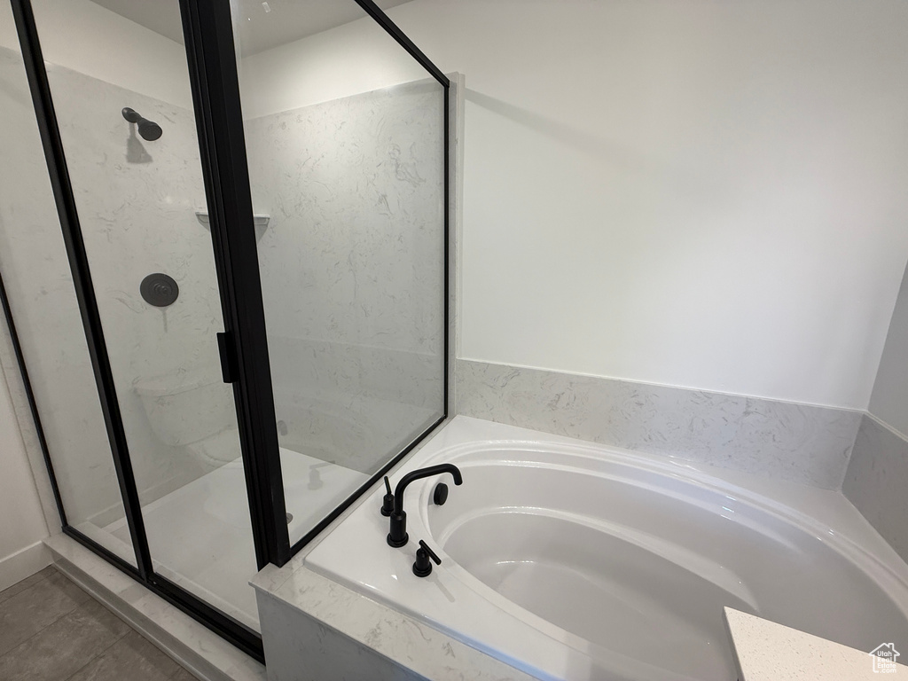 Full bathroom with a garden tub, a shower stall, and tile patterned floors