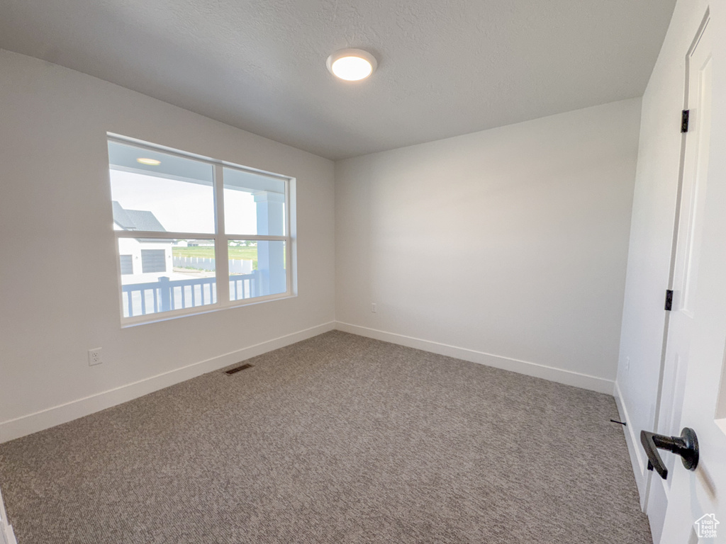 Spare room featuring carpet floors