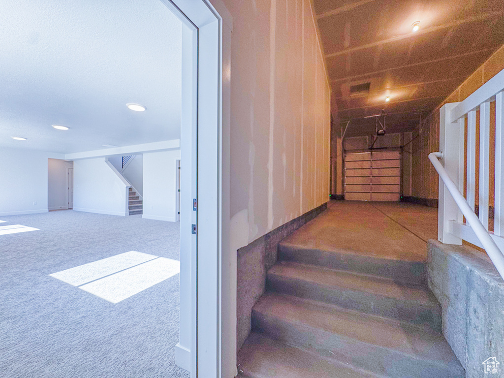 Stairway with carpet and recessed lighting