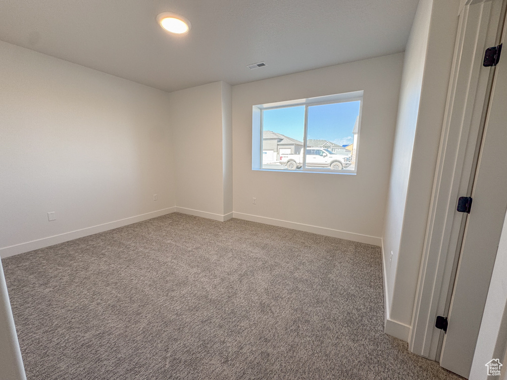 Unfurnished room featuring baseboards and carpet flooring