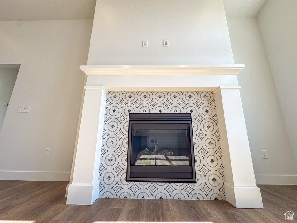 Detailed view of wood finished floors and a fireplace