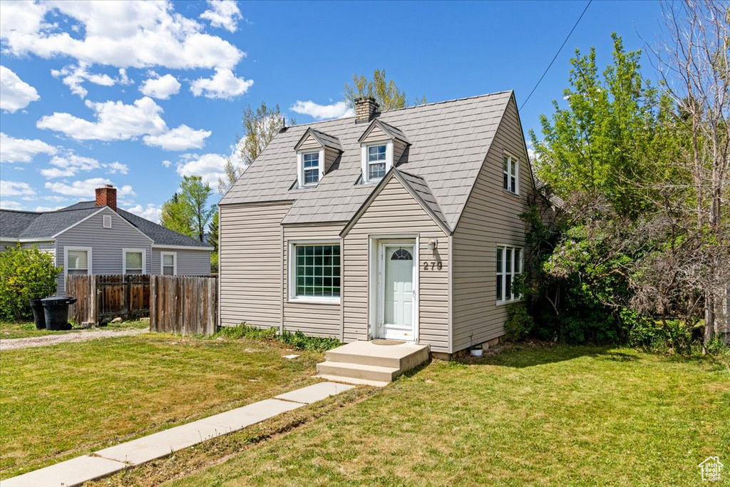 Cape cod house featuring a chimney