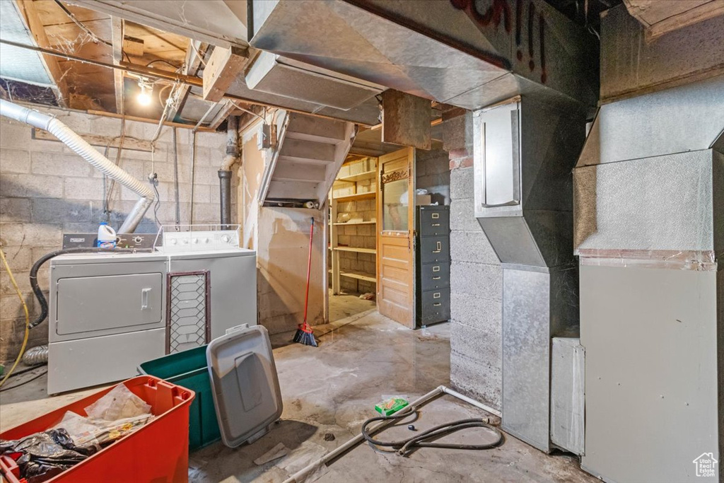 Unfinished below grade area with washing machine and dryer