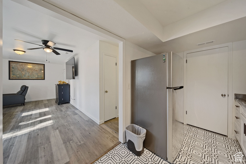 Bathroom featuring a ceiling fan, wood finished floors, and baseboards