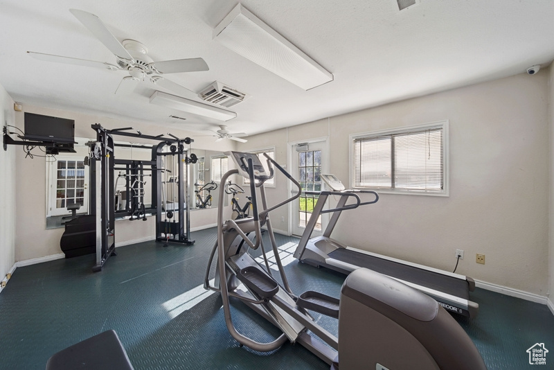 Exercise room featuring baseboards and a ceiling fan