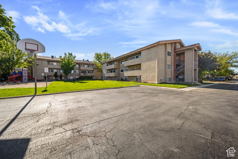 View of property featuring uncovered parking