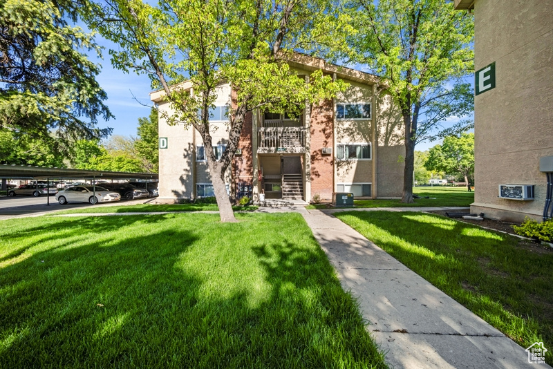 Surrounding community with a lawn and covered parking