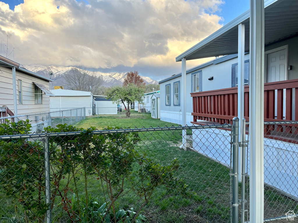 Yard at dusk with a mountain view and a gate