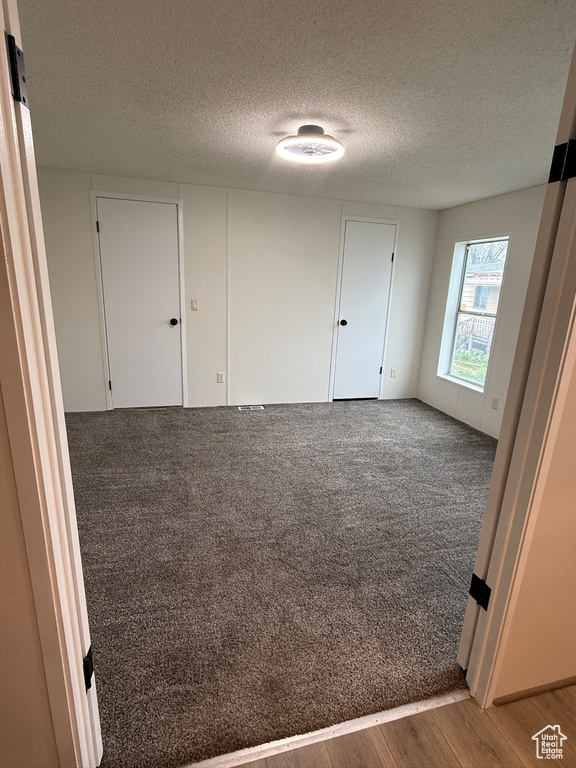 Unfurnished room featuring a textured ceiling and light wood-type flooring