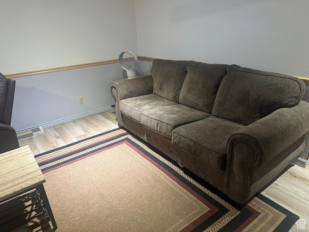 Living area with wood finished floors and baseboards