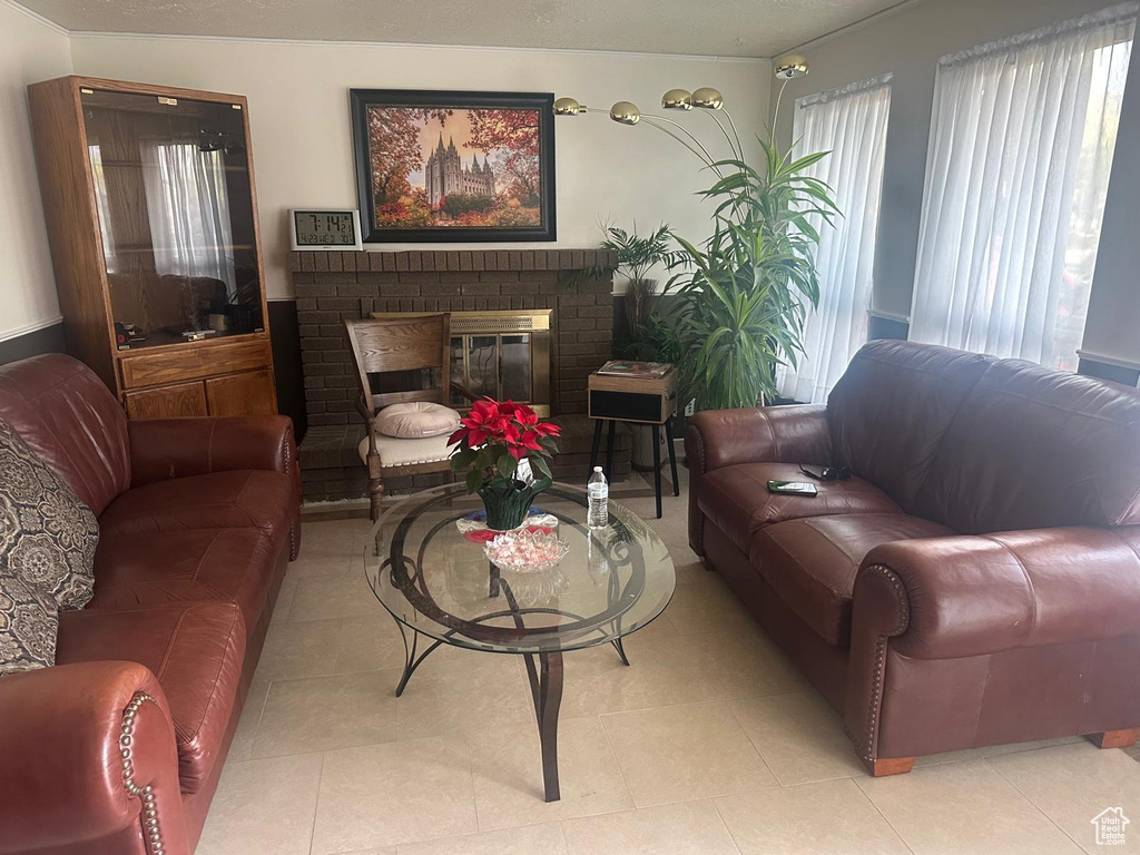 Living area featuring a fireplace and light tile patterned floors