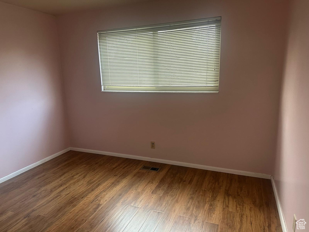 Empty room with wood finished floors and baseboards