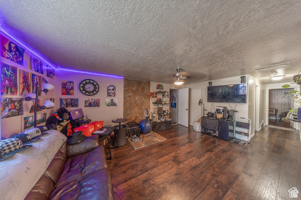 Living room featuring wood finished floors and a textured ceiling