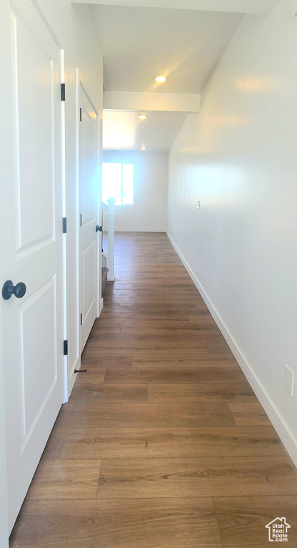 Hall with baseboards, wood finished floors, and recessed lighting