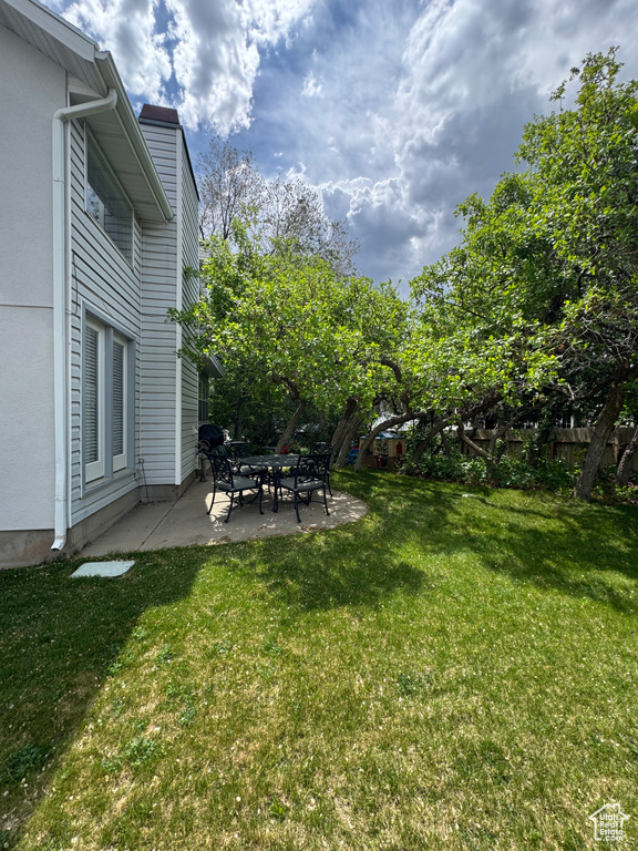 View of green lawn featuring a patio area