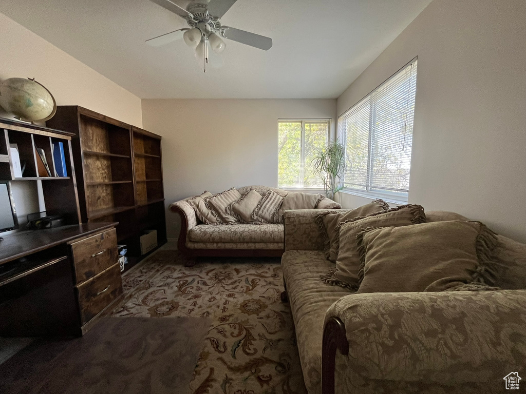 Living room with a ceiling fan and carpet floors