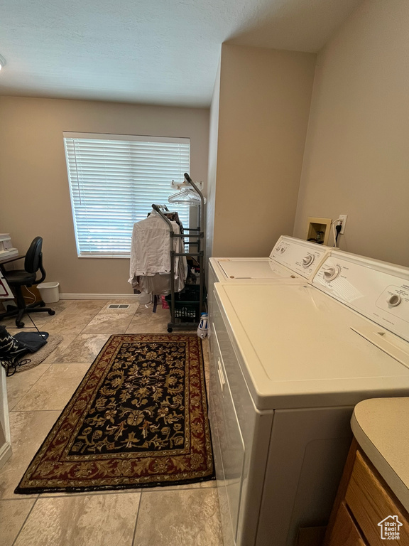 Clothes washing area with washing machine and dryer and baseboards