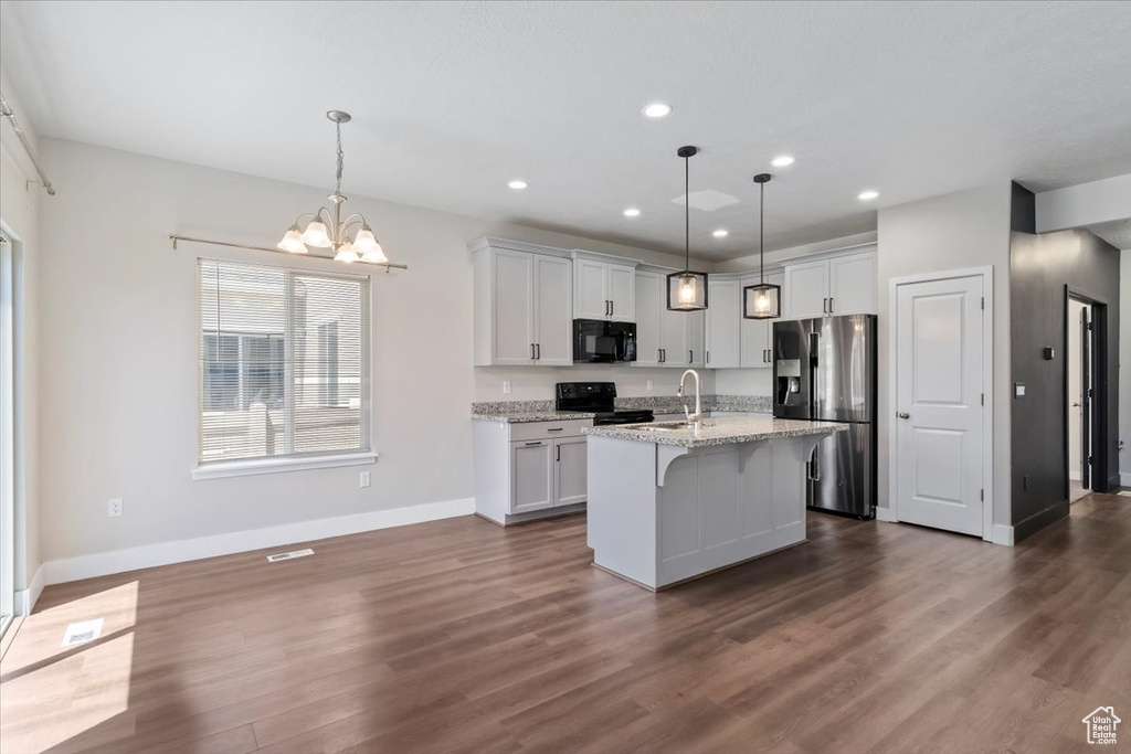 Kitchen with black appliances, baseboards, dark wood-style flooring, a chandelier, and recessed lighting